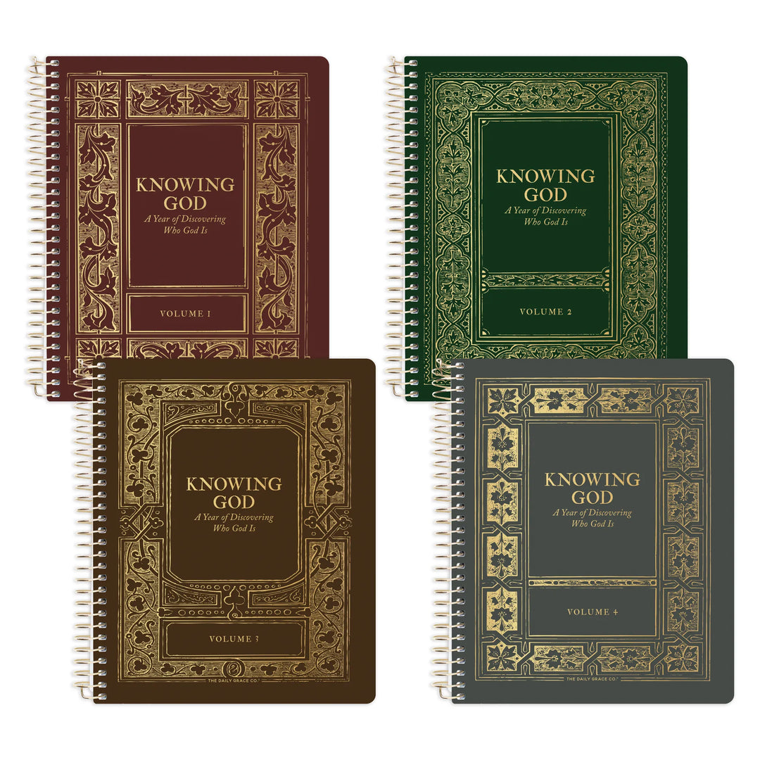Four spiral-bound books titled 'KNOWING GOD: A Year of Discovering Who God Is' arranged in a 2x2 grid. The covers are in different colors: burgundy, dark green, dark brown, and charcoal gray, each with ornate gold decorative border designs and gold lettering.