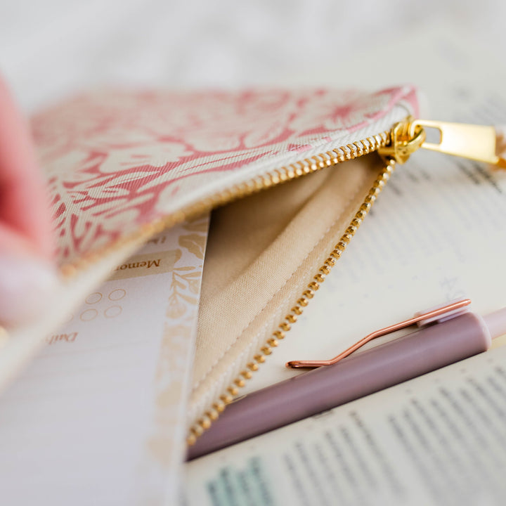 Hand showing the inside of the Laurel Accessory Pouch - Blossom Pink.