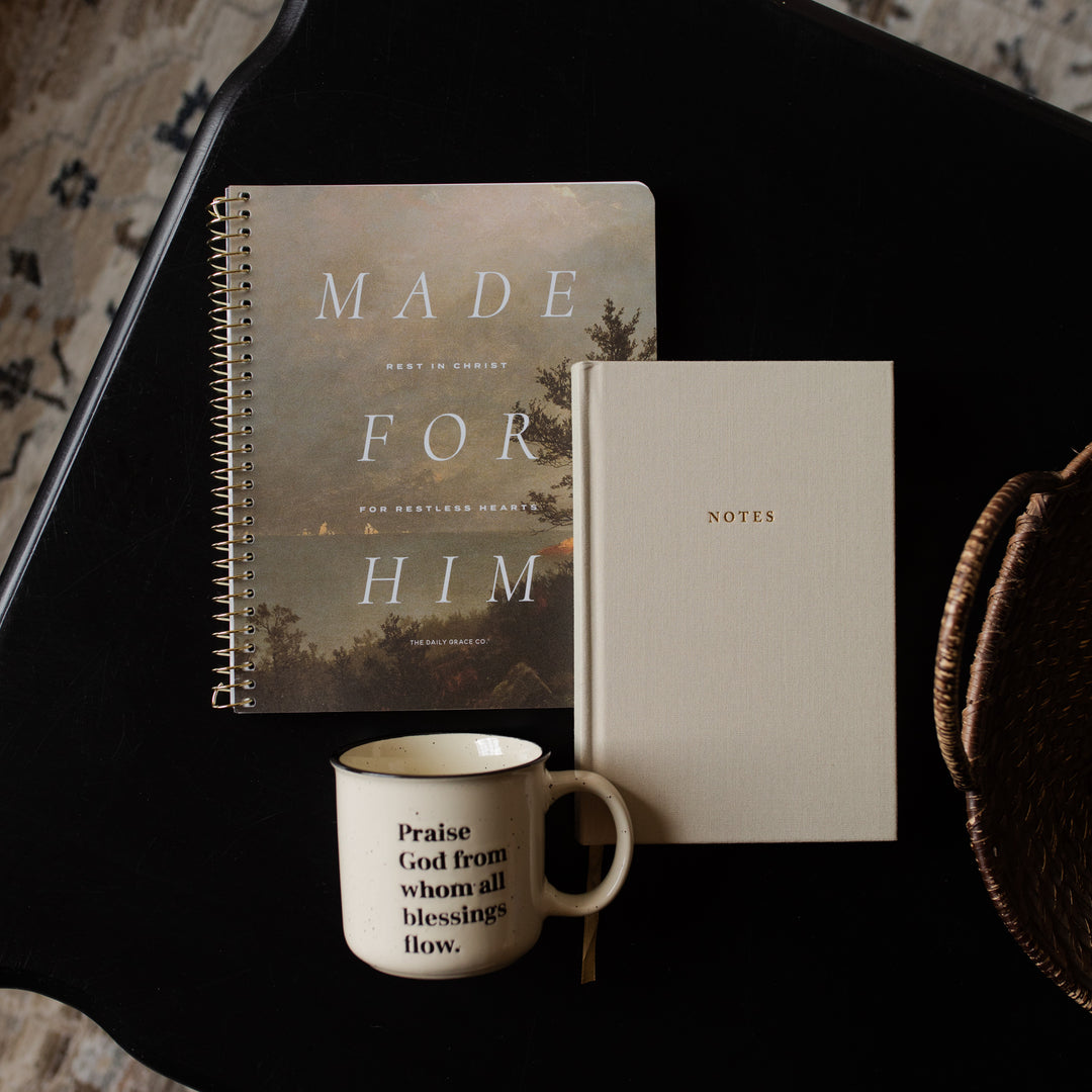Notebook titled 'Made for Him' and a smaller notebook titled 'Notes' on a dark surface with a mug.