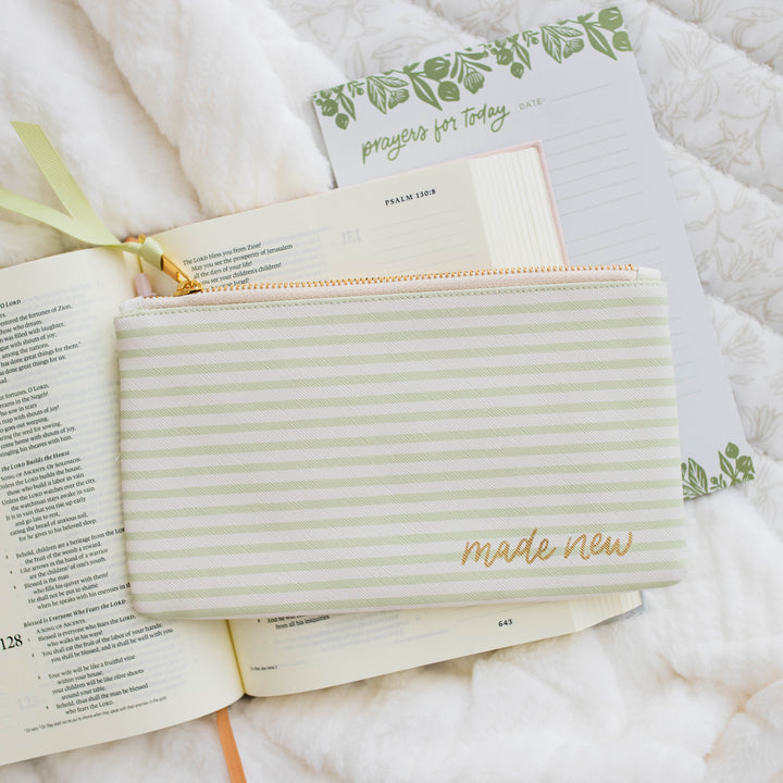 Made New Pencil Pouch - Green Stripe laying on top of a Bible and Prayers for Today notepad