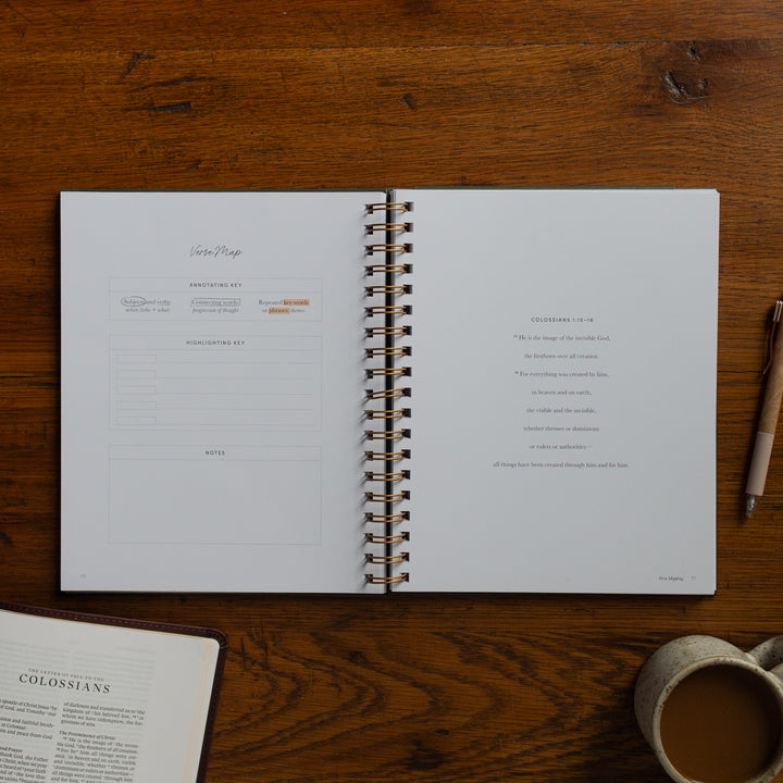 Mark It Up Journal opened to the verse map page next to a pen