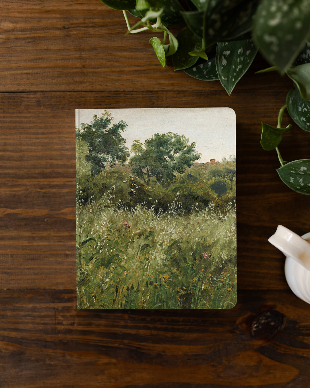 Notebook with nature-themed cover on a wooden surface