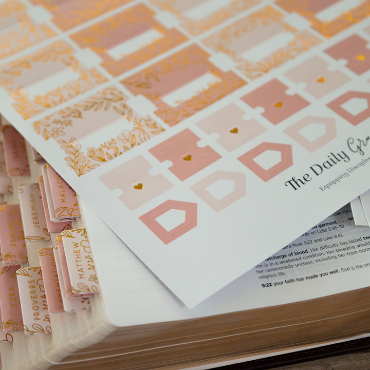 Stack of books with decorative covers and text on a wooden surface