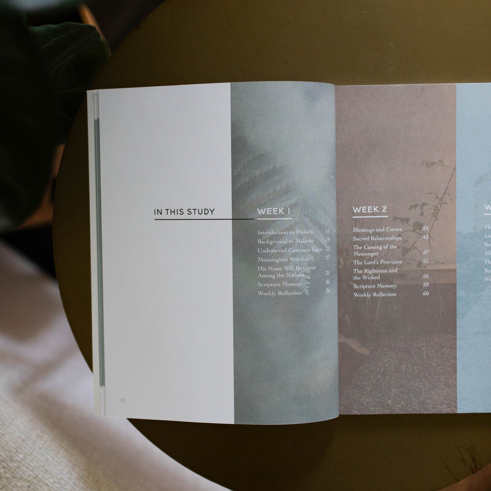 Mens Malachi Waiting for Hope Bible Study opened to the table of contents by week page sitting on a gold colored table