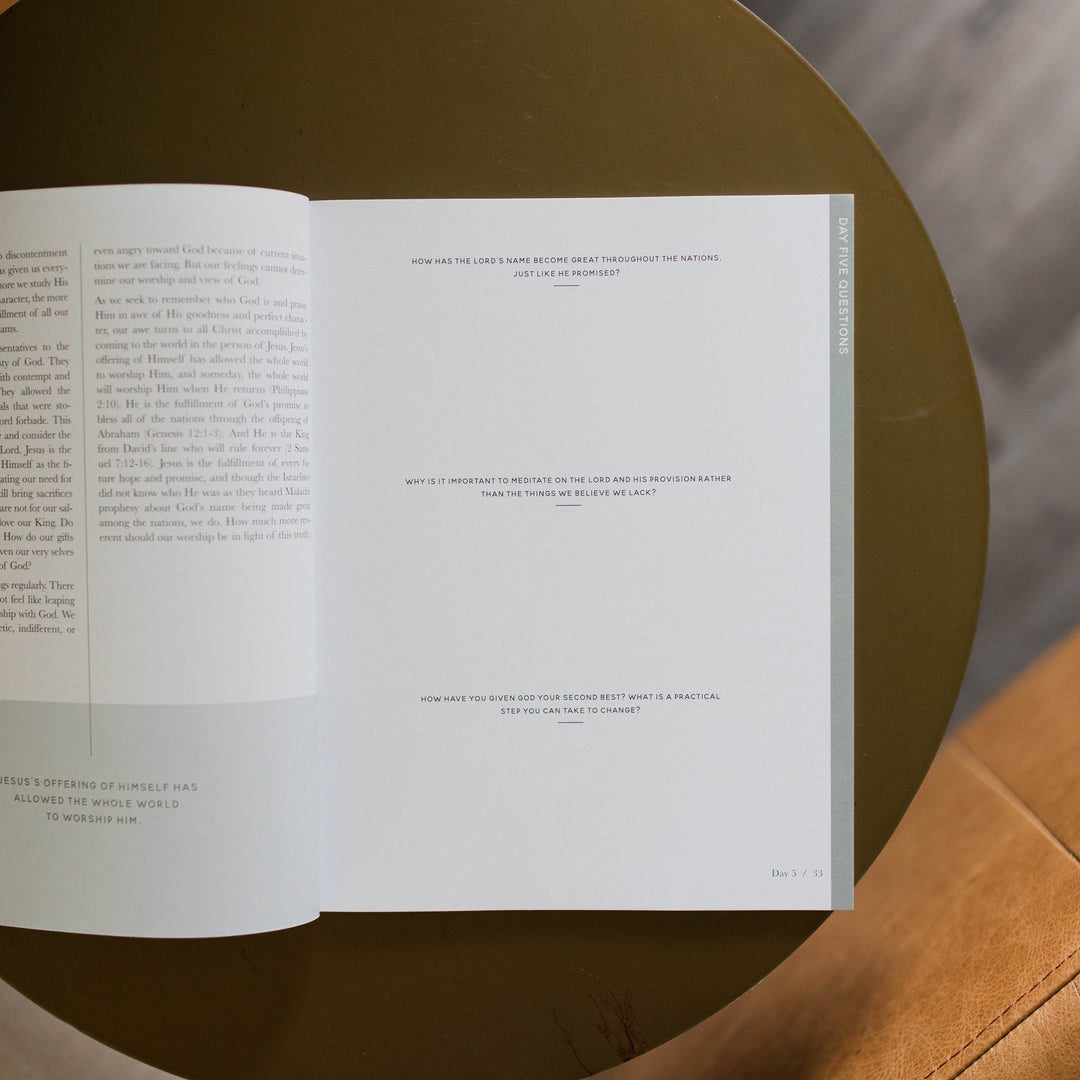 Mens Malachi Waiting for Hope Bible Study opened to Week 1s questions page sitting on a gold colored table