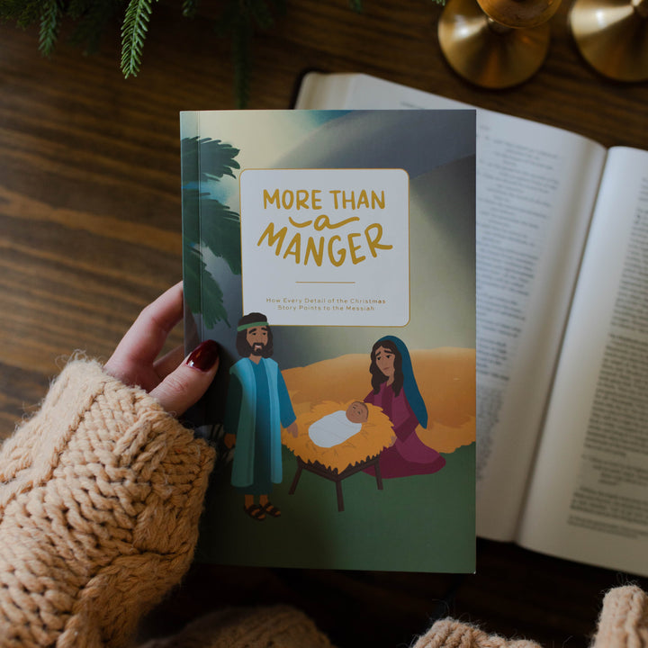 Woman holding More Than a Manger Family Devotional