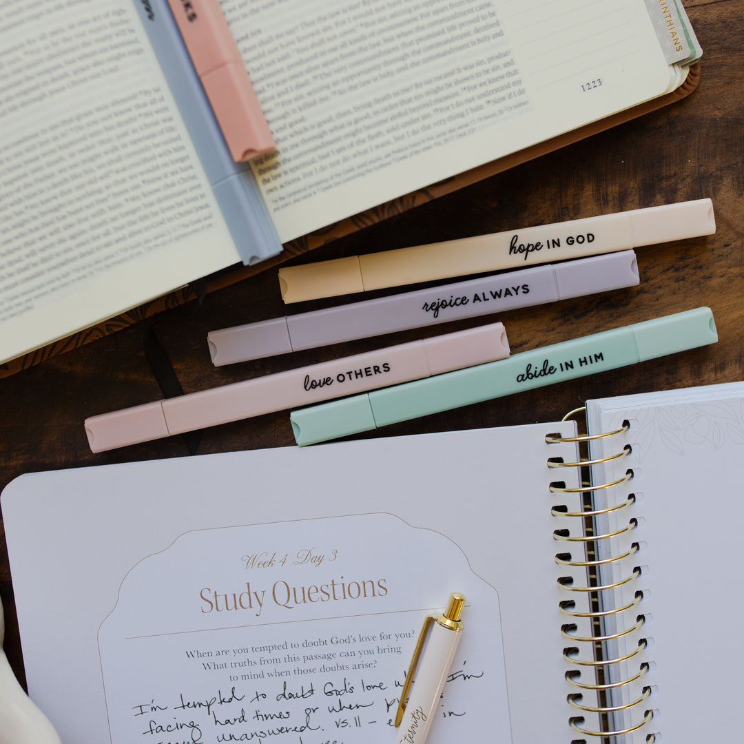 Open Bible with no bleed Bible highlighters on a wooden surface