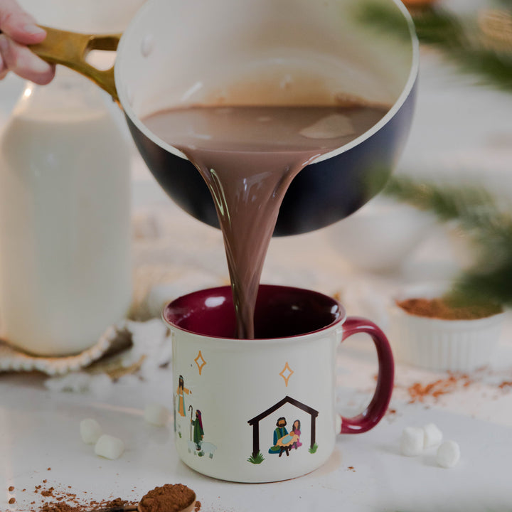 Hot chocolate being poured into Christmas Nativity Mug 