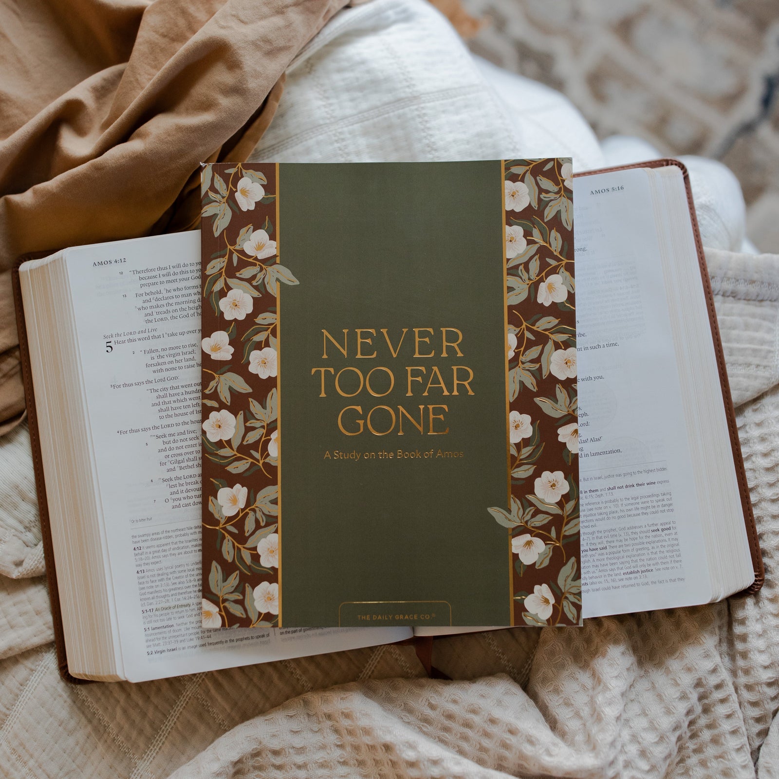 Never too far gone study laying on a open bible on multiple blankets.