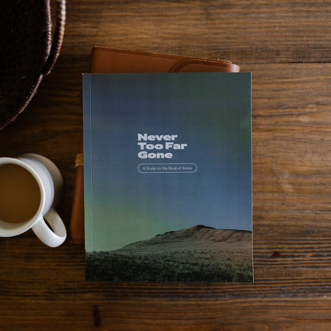 Never too far gone men's study cover laying on a leather bible next to a cup of coffee on a wooden table