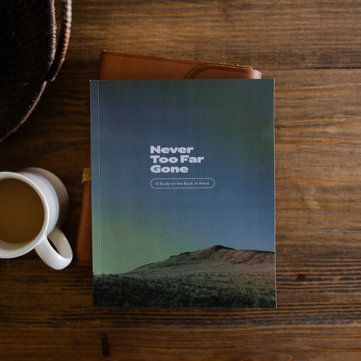 Never too far gone men's study cover laying on a leather bible next to a cup of coffee on a wooden table