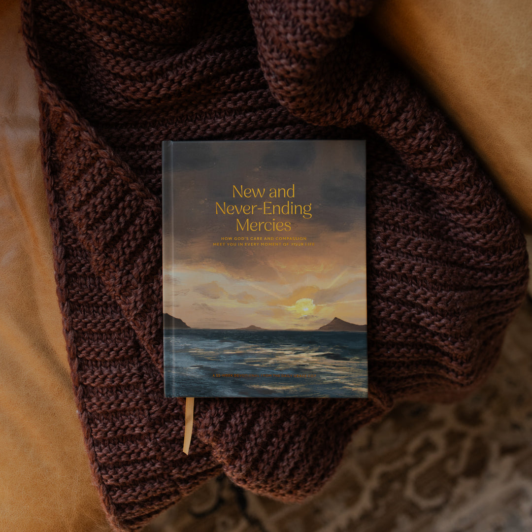 New and Never Ending Mercies on a brown knitted blanket on a leather couch