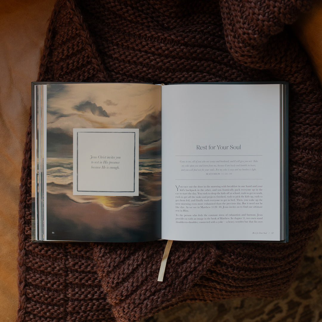 New and Never Ending Mercies opened to the Rest for Your Soul page on a brown knitted blanket on a leather couch