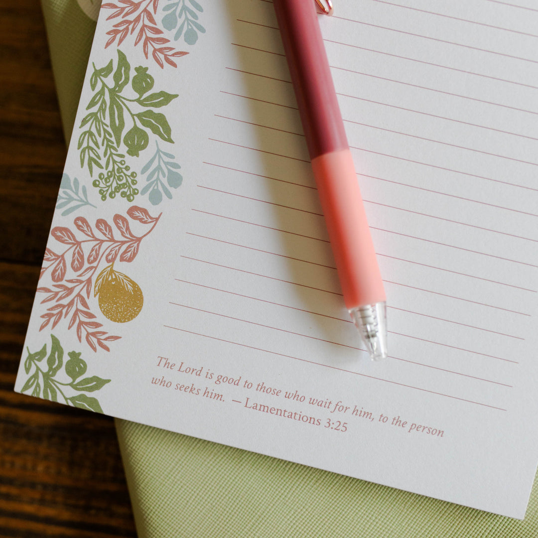 Image of a notepad with a coral pen and the Lamentations 3:25 Bible verse.