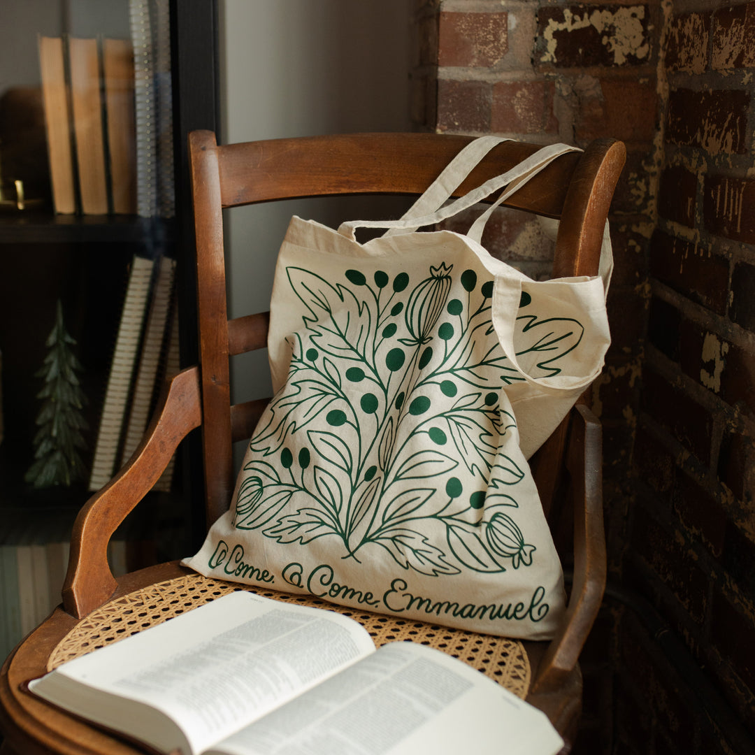 O Come O Come Emmanuel Tote on a wooden chair near an open bible