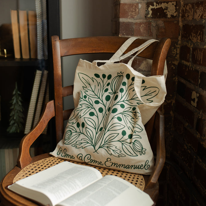 O Come O Come Emmanuel Tote on a wooden chair near an open bible