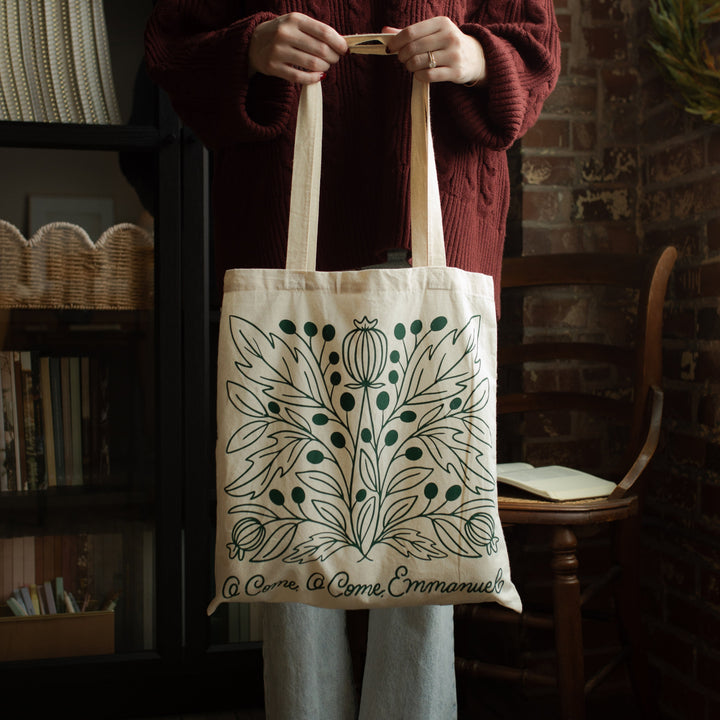 O Come O Come Emmanuel Tote being held by the handles by a woman