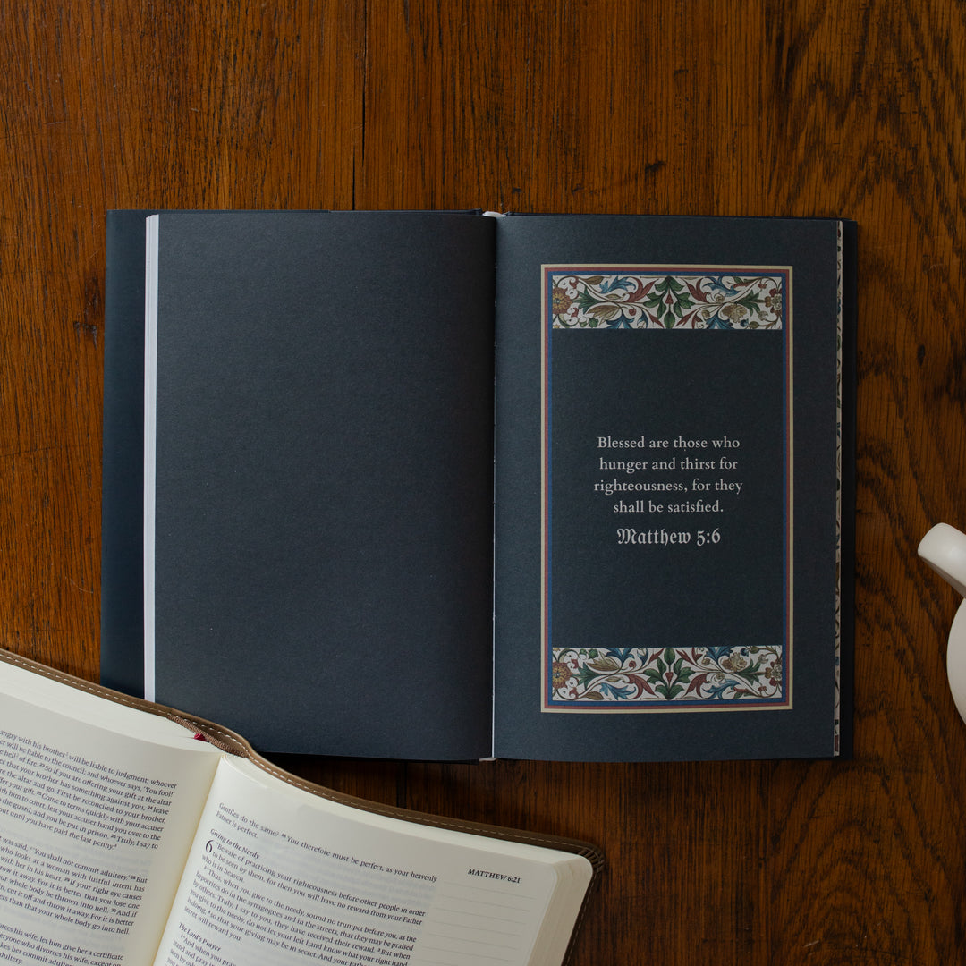 Open book with decorative text on a wooden surface