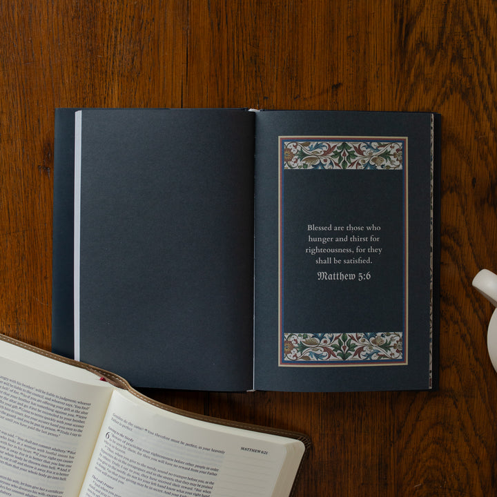 Open book with decorative text on a wooden surface