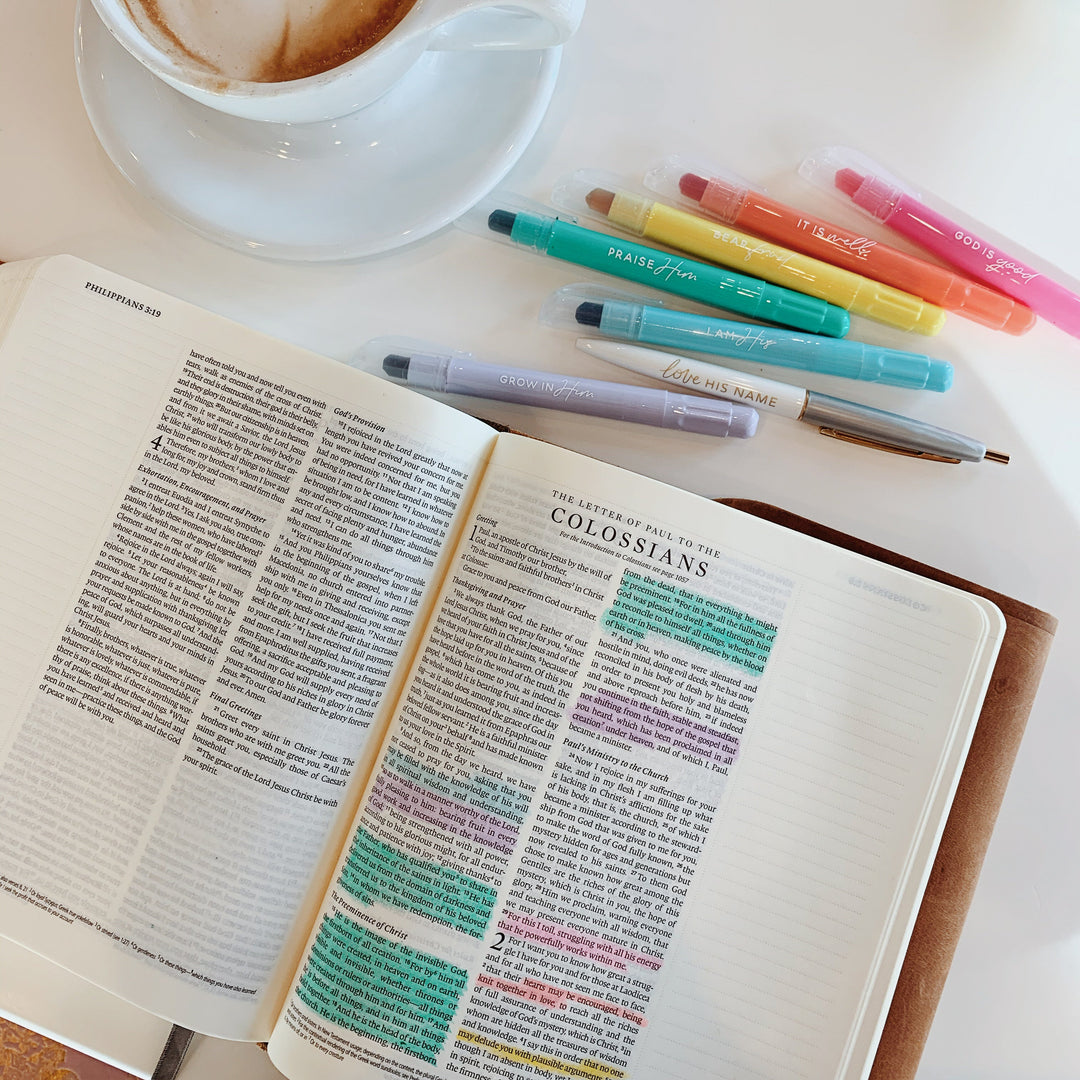 Pastel Bible highlighters next to a Bible