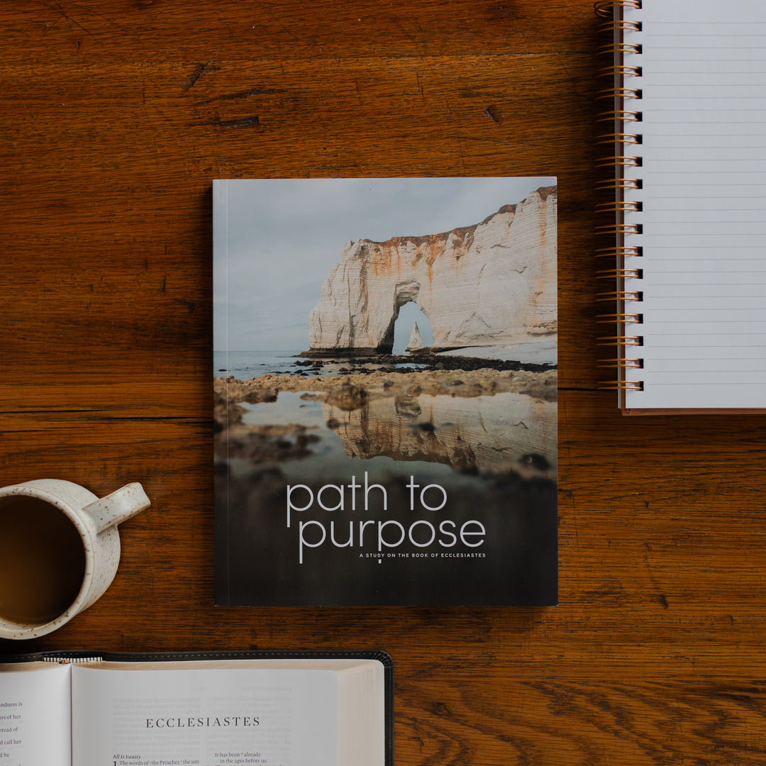 The Path to Purpose cover on a wooden table near a coffee cup