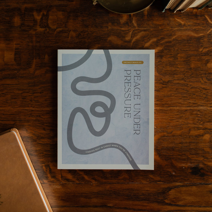 Peace Under Pressure Study Cover on a wooden table next to a closed journal