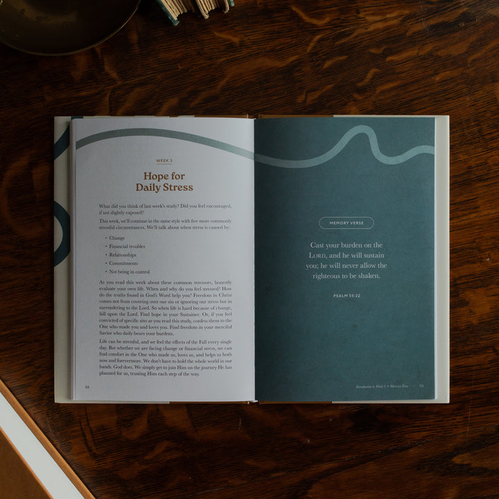 Peace Under Pressure Mens opened to the week 3 memory verse page on a wooden table next to a journal