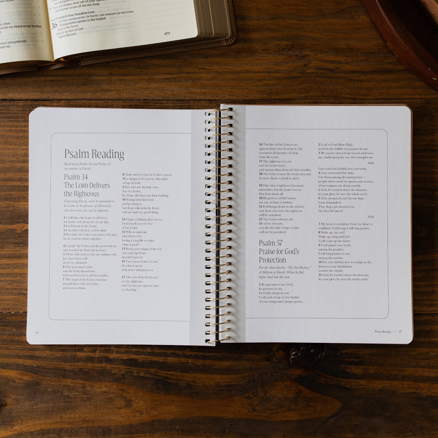 Peaks and Valleys Spiral Study opened to the Psalm Reading page next to a dark brown wooden tray and an open bible on a brown wooden table