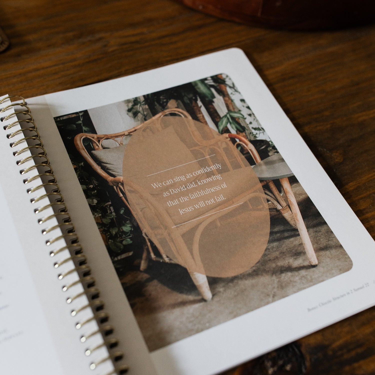 Peaks and Valleys Spiral Study opened to a small devotional page next to a dark brown wooden tray on a brown wooden table