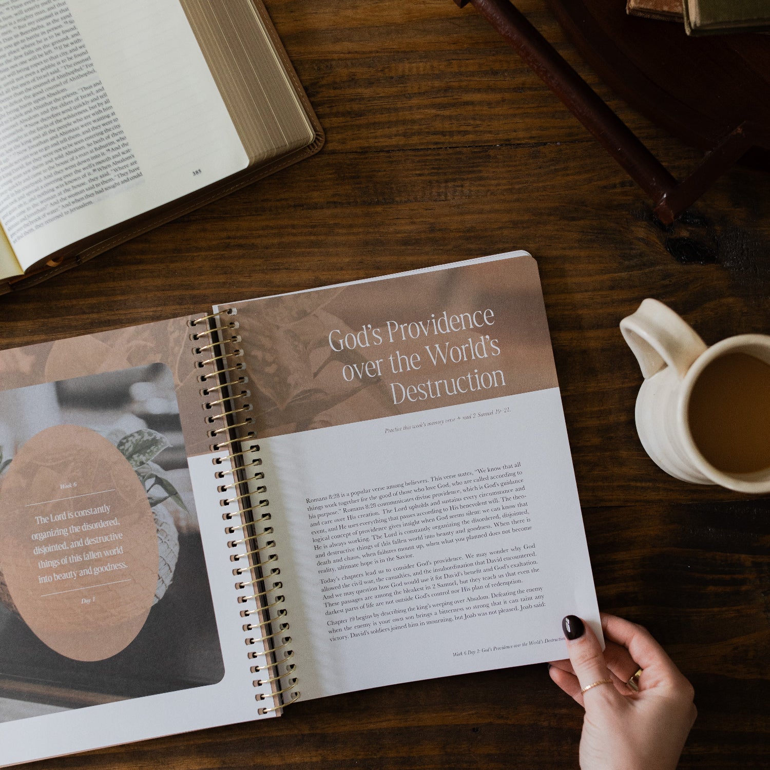 Peaks and Valleys Spiral Study opened to the God's Providence page next to a dark brown wooden tray and an open bible on a brown wooden table
