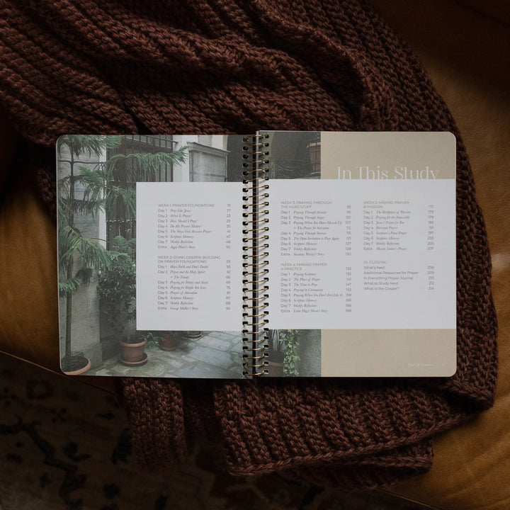 The Pray Spiral Study opened to the table of contents page on a woven blanket