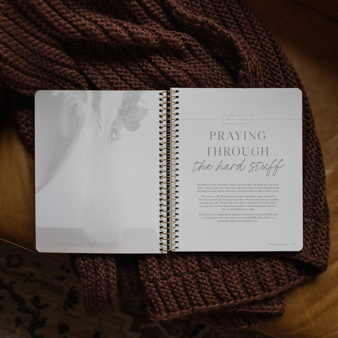 The Pray Spiral Study opened to the week three page on a woven blanket
