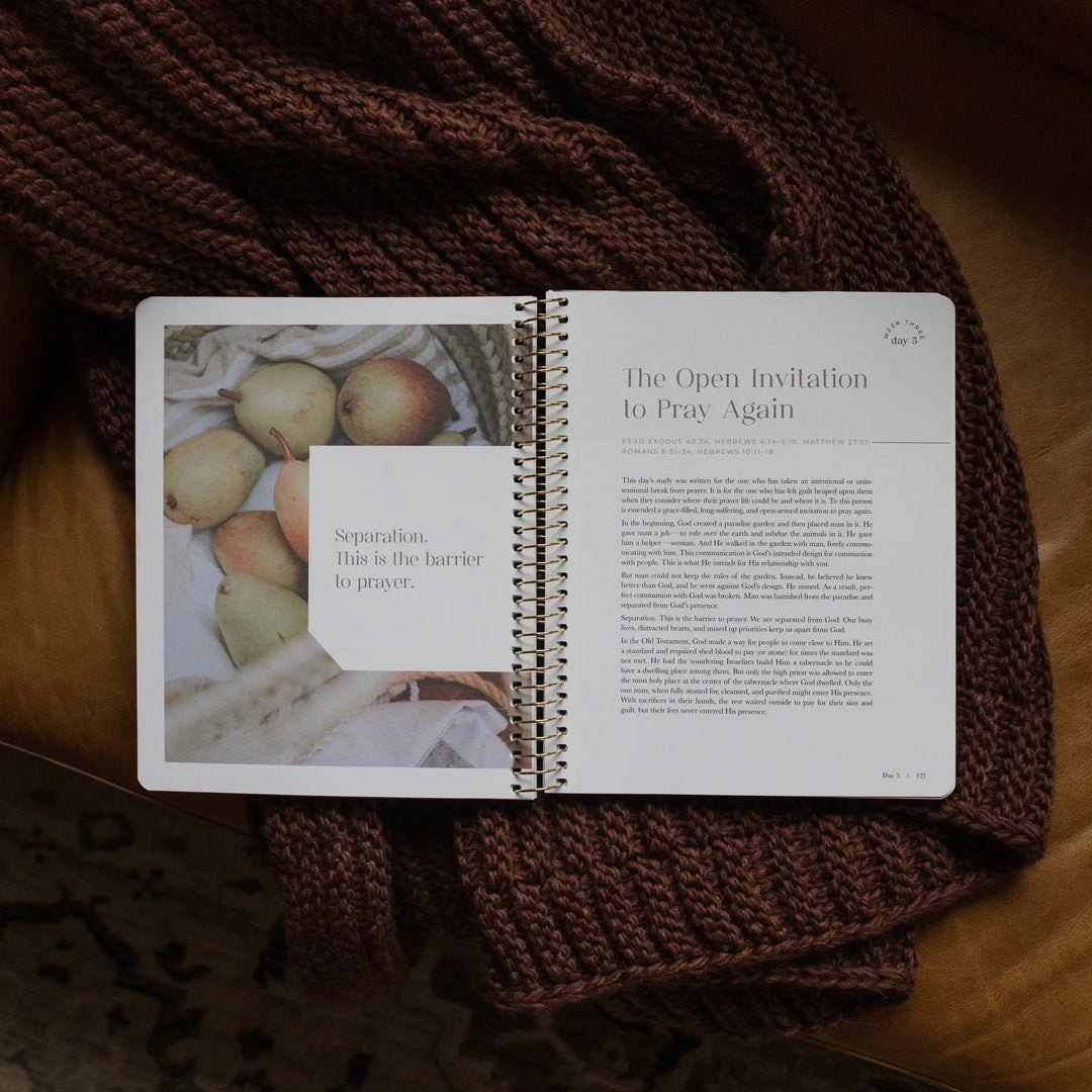 The Pray Spiral Study opened to the week three day 5 page on a woven blanket