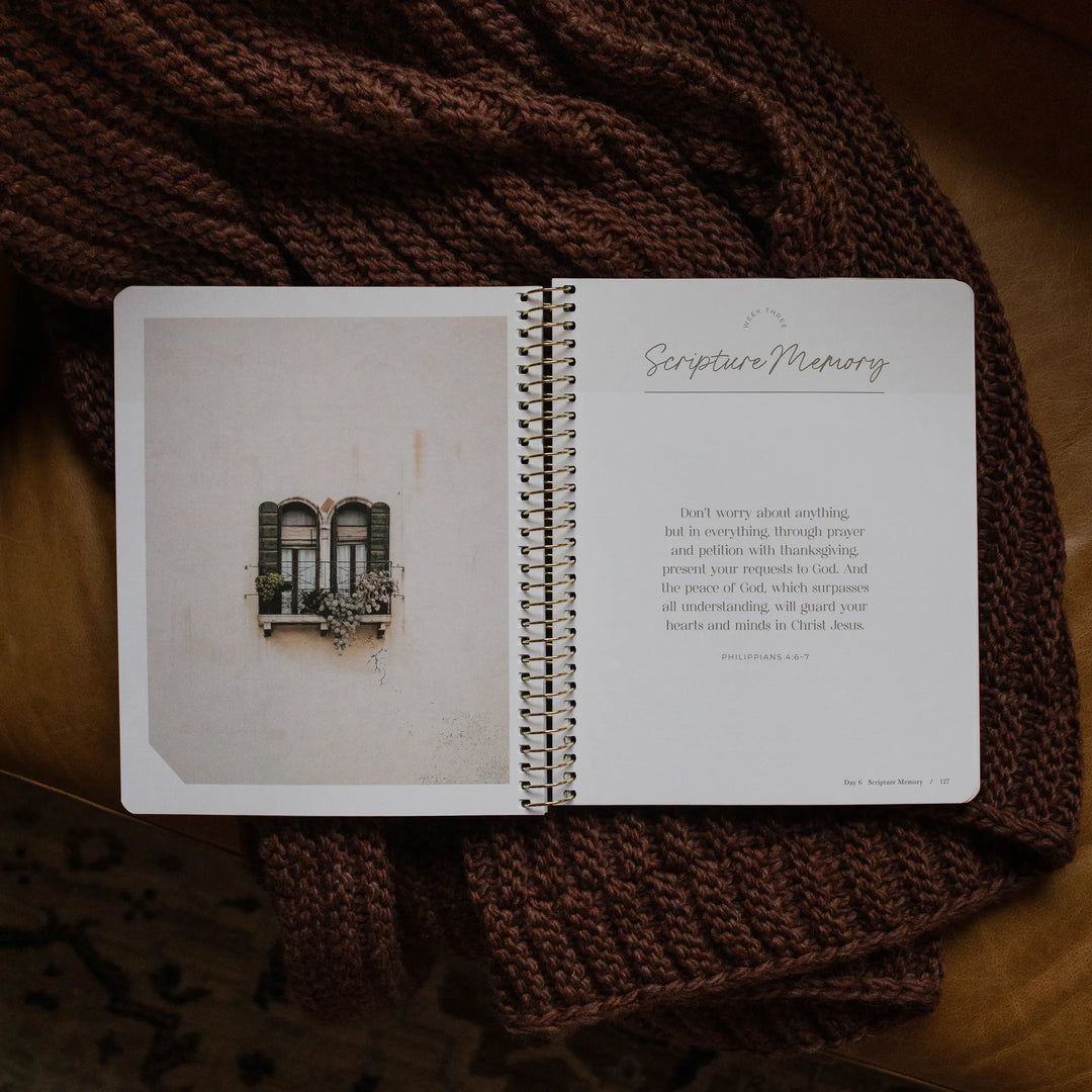 The Pray Spiral Study opened to the scripture memory page on a woven blanket