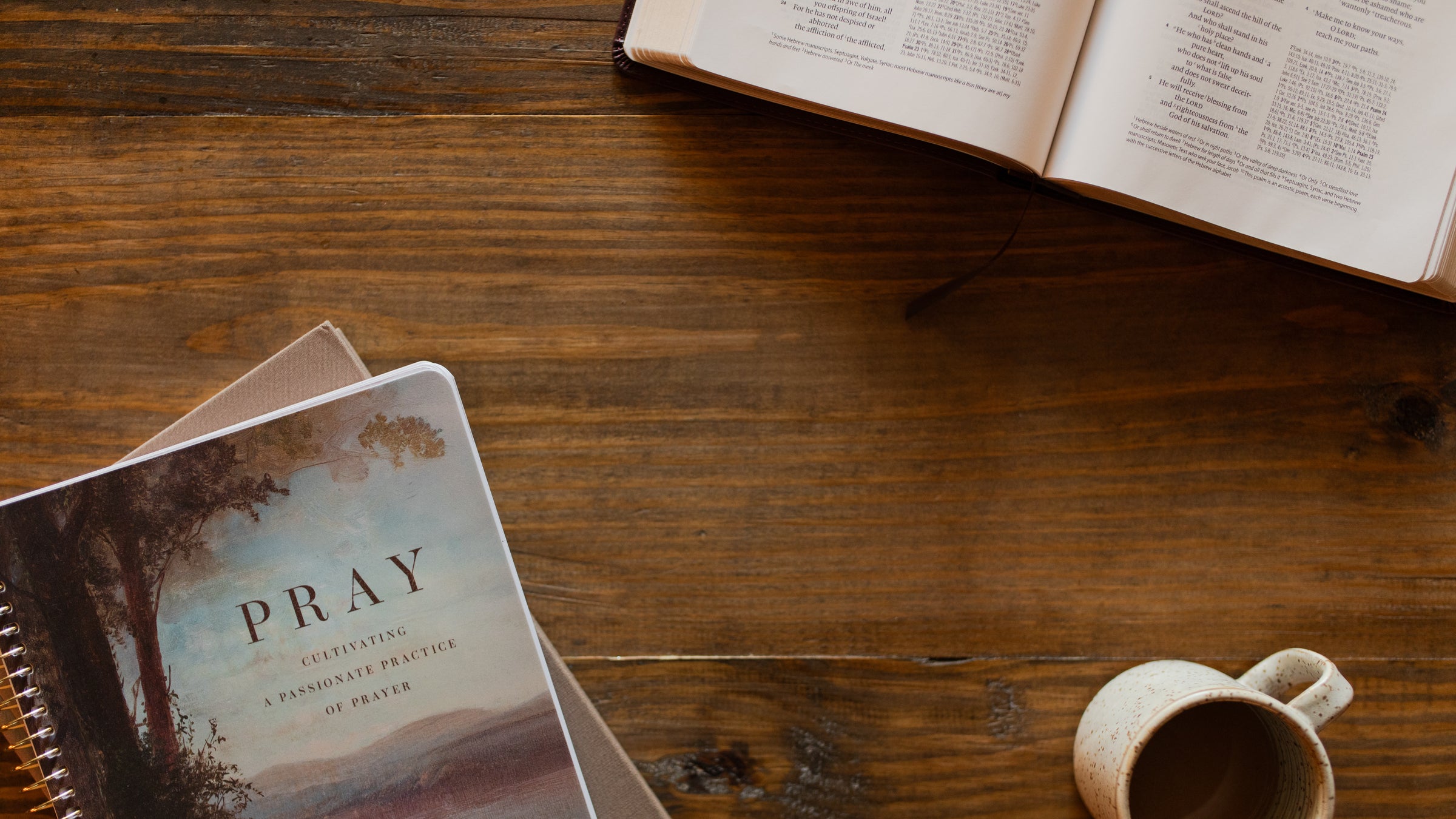 The pray spiral and an open bible on a wooden table