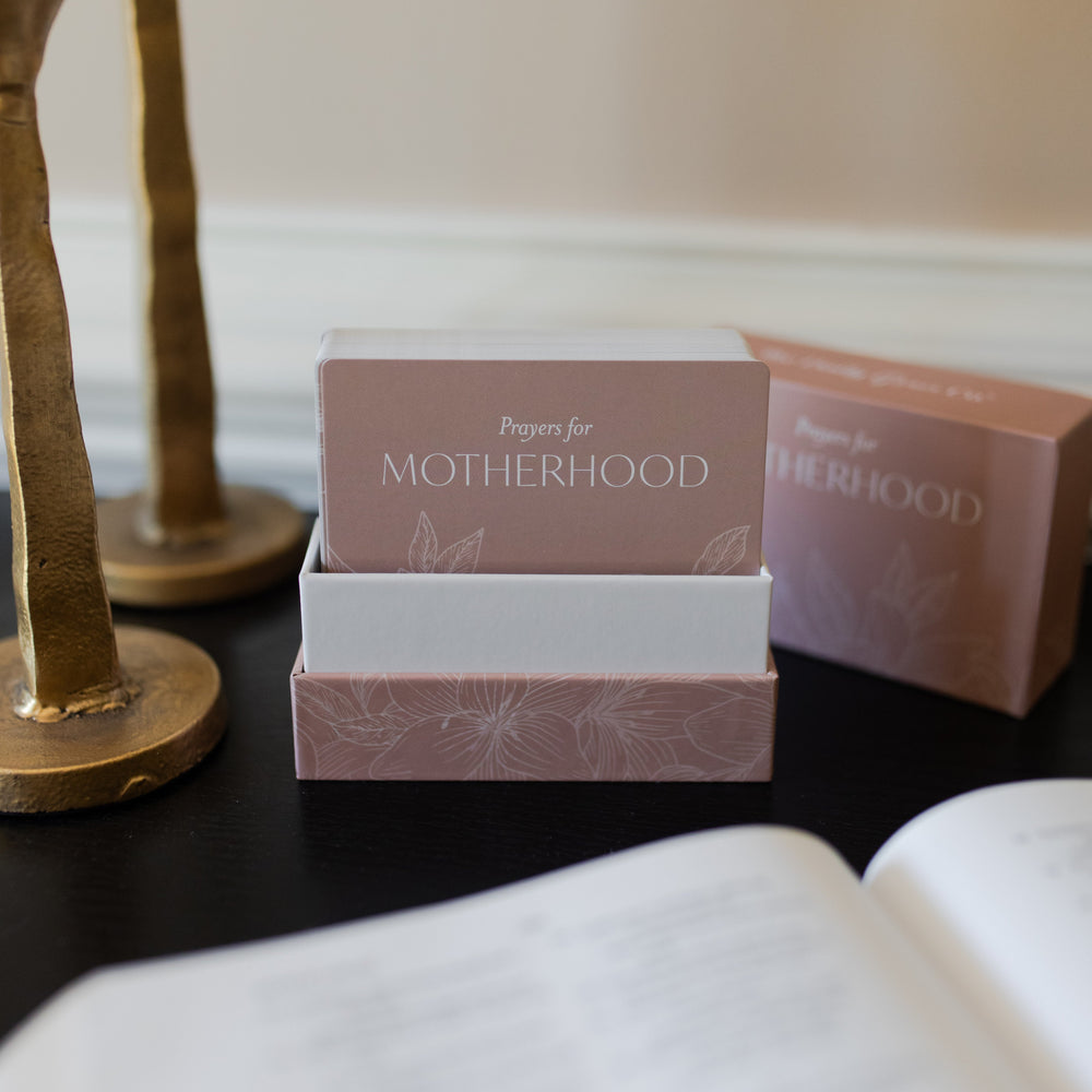 Prayers for Motherhood verse cards in a pink flowery case opened to reveal multiple cards on a dark table