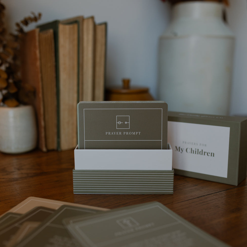 A Box opened, showing verse cards for prayers for children on a wooden desk