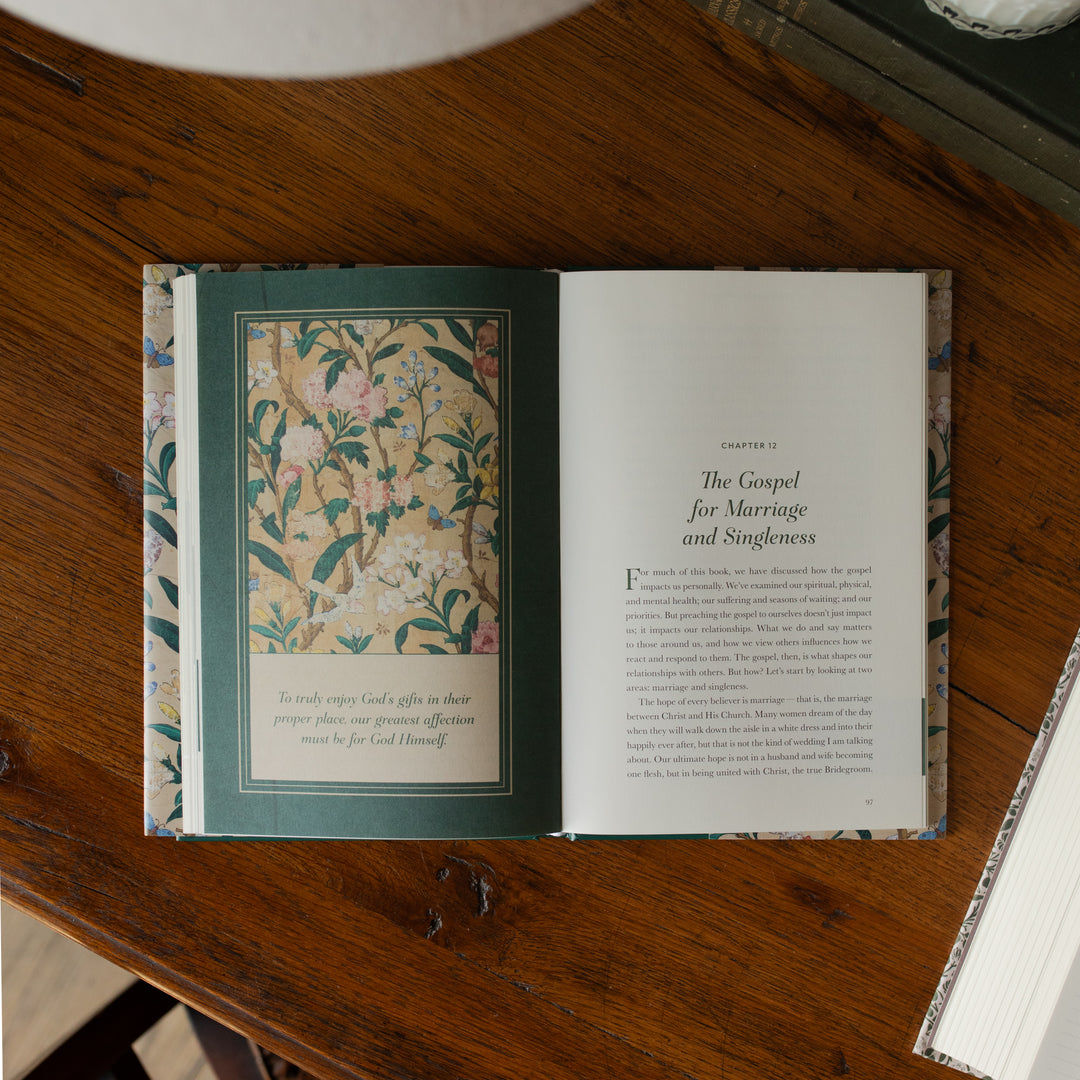 Preaching the Gospel to yourself opened to Chapter 12 beginning page on a wooden table