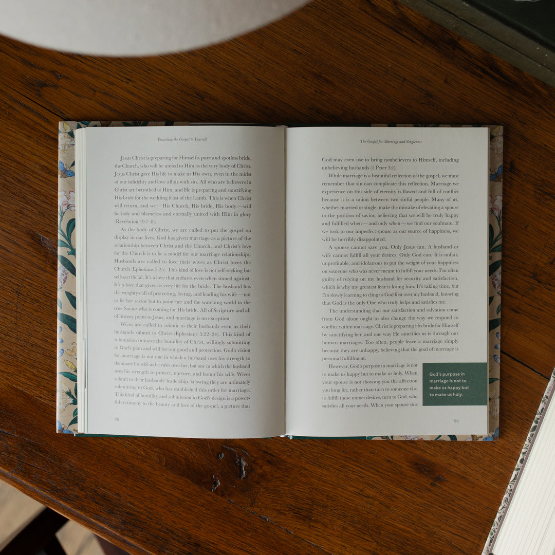 Preaching the Gospel to yourself opened to a portion of reading on page 99 on a wooden table