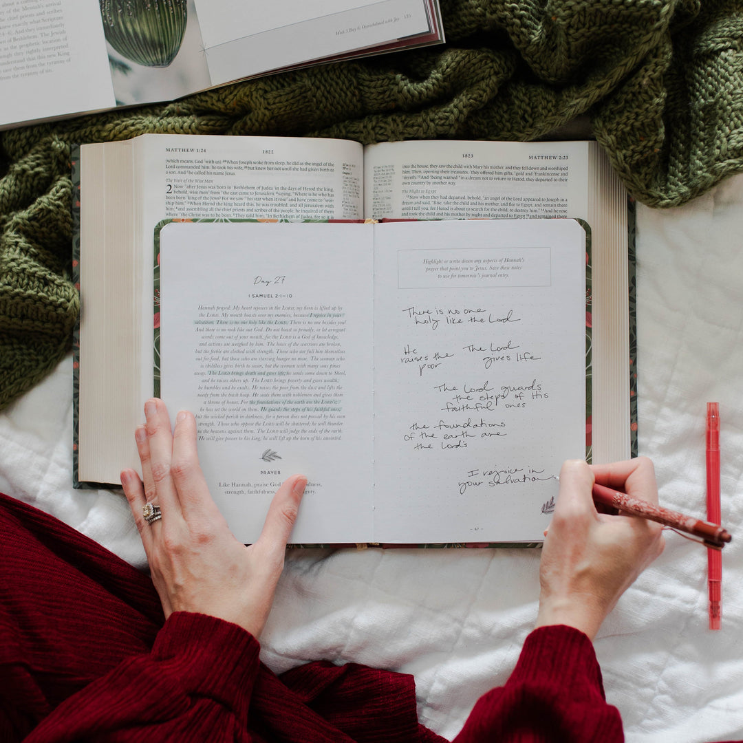 Woman writing in Prepare Him Room Daily Advent Journal for Prayer and Reflection