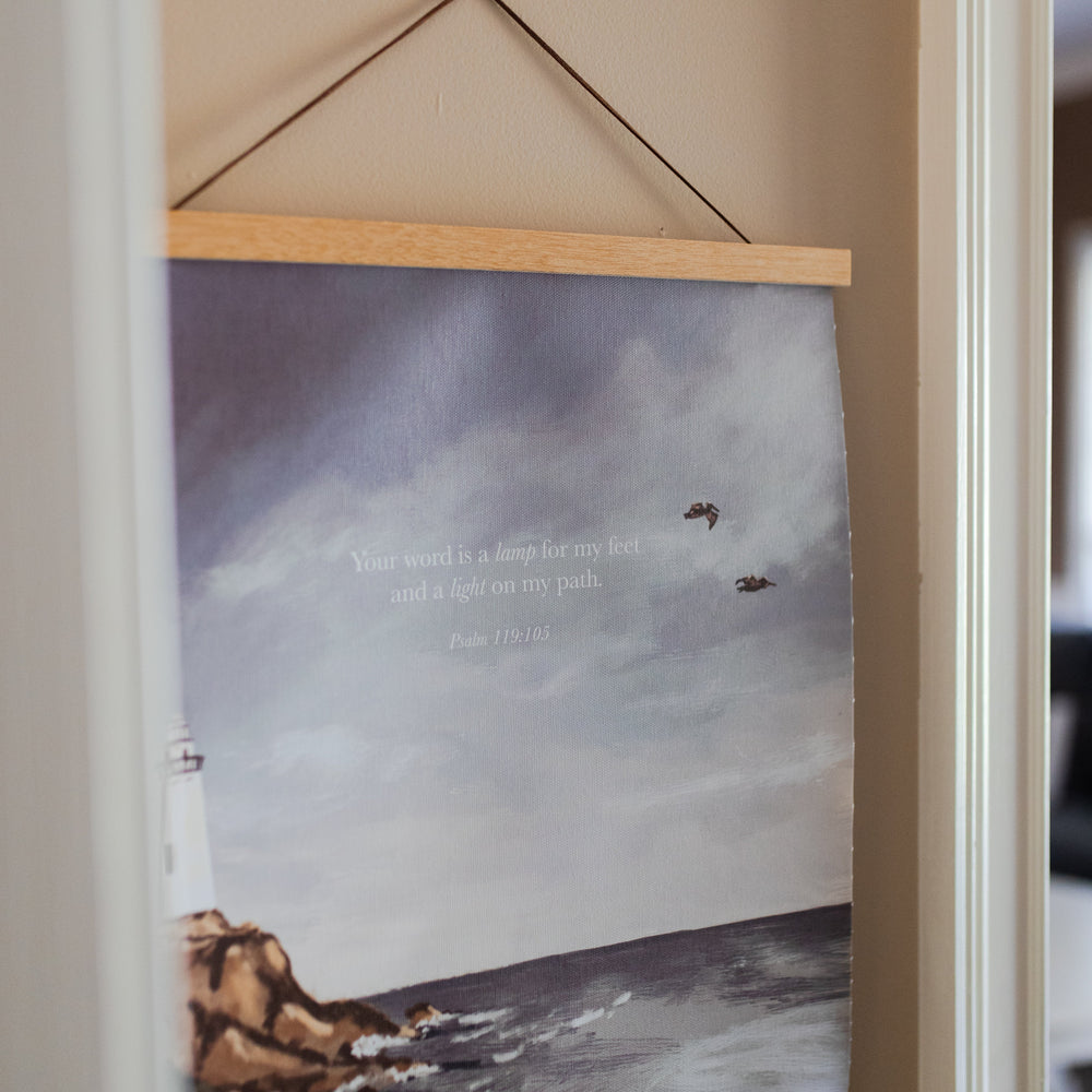 Psalm 119 Lighthouse Painting Print at an angle on a light colored wall with white trim