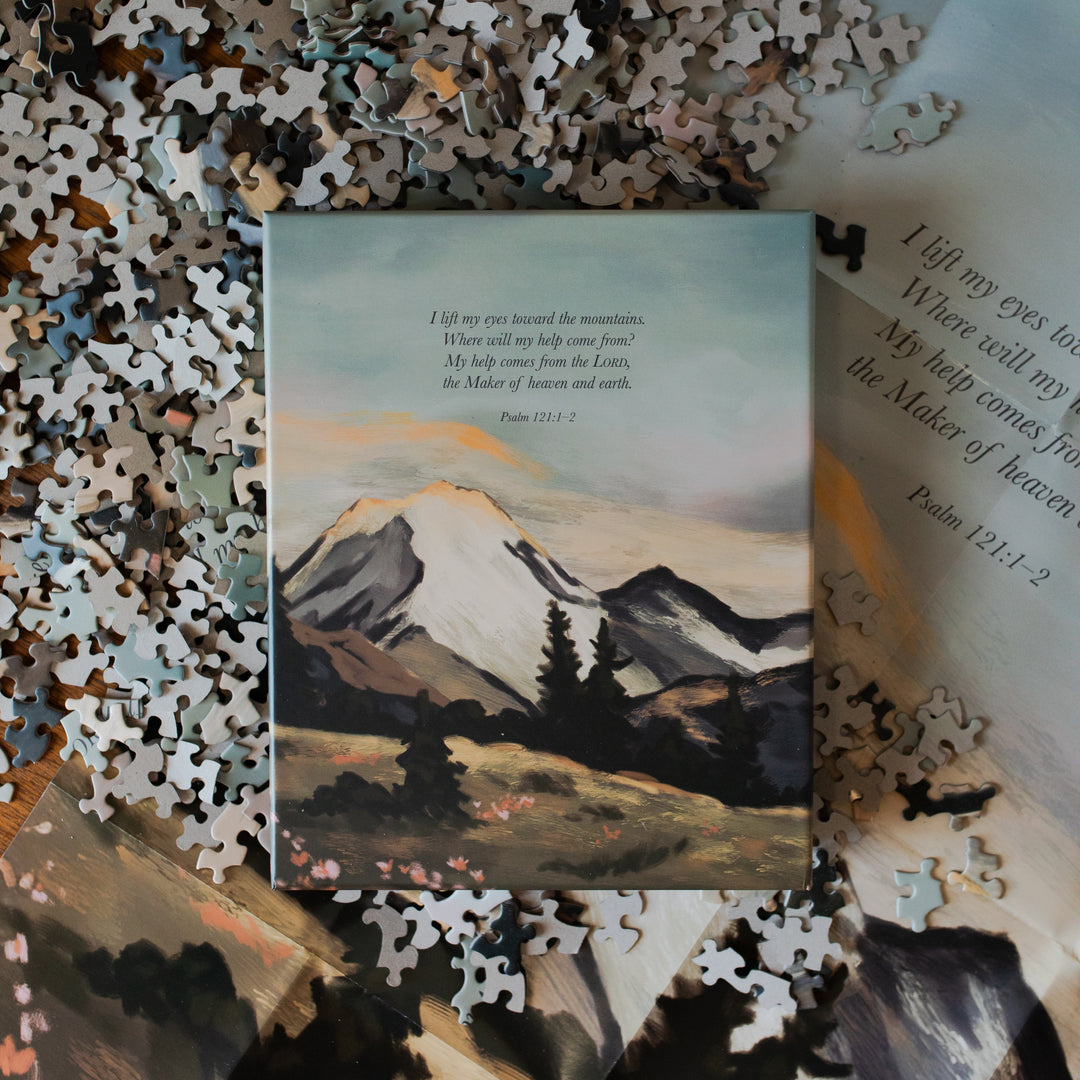 Psalm 121 Puzzle box laying on all of the puzzle pieces on the table