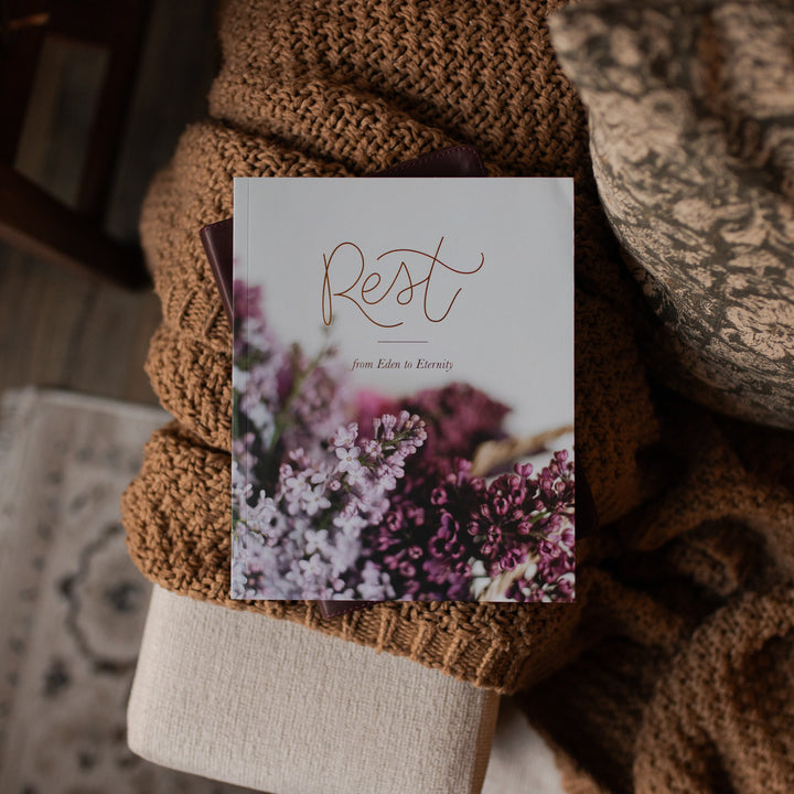 The Rest Matte study cover on a closed bible and on a woven brown blanket