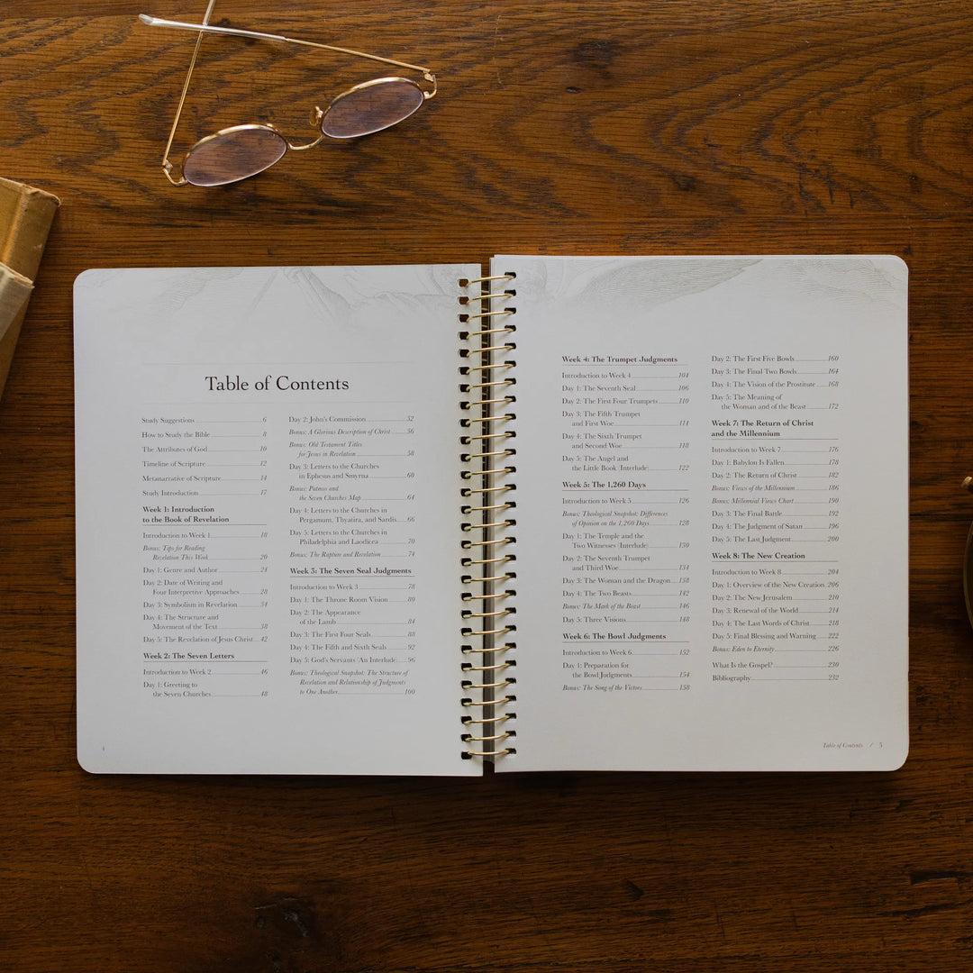 Revelation Spiral Study opened to the table of contents page on a wooden table next to a pair of glasses