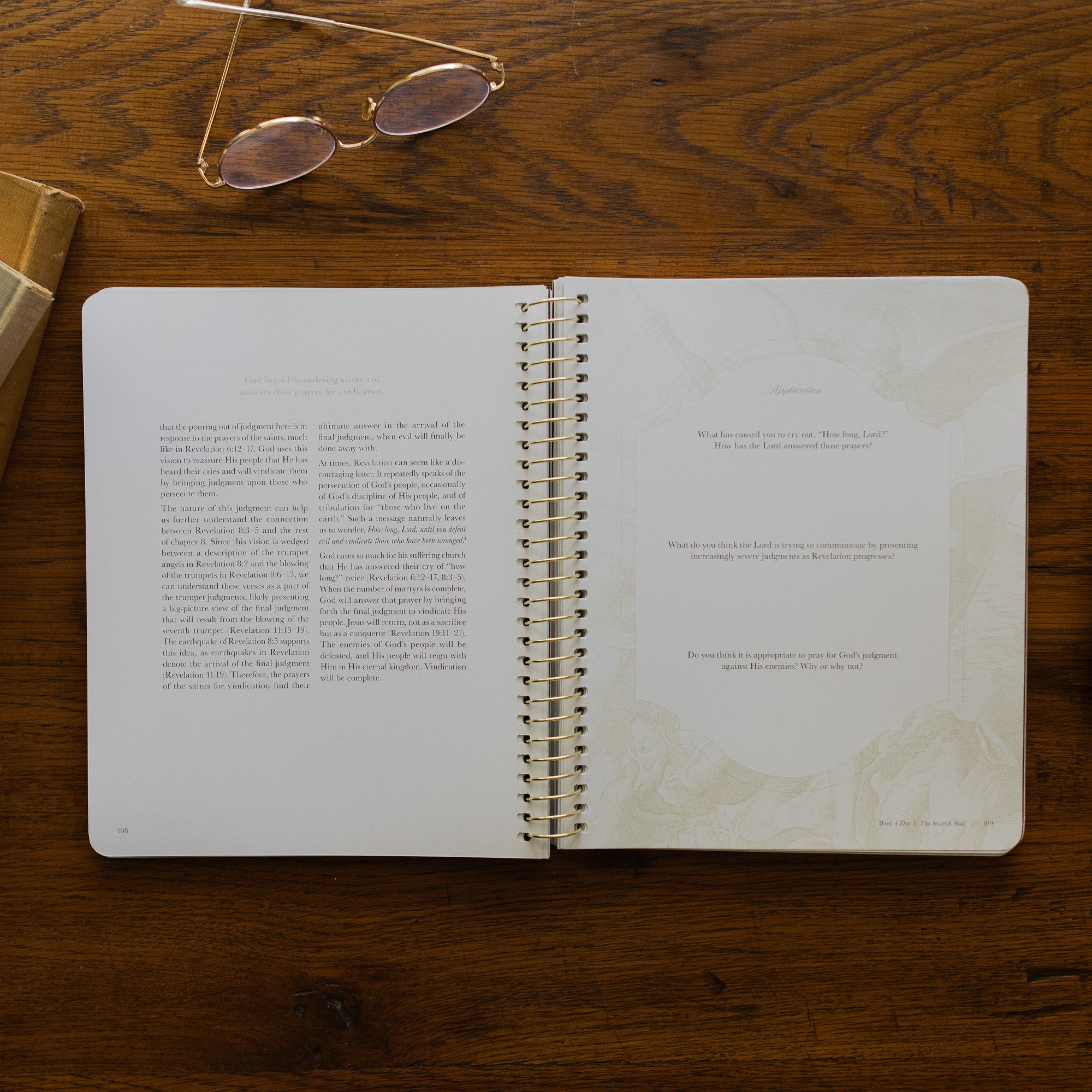 Revelation Spiral Study opened to page 108, Questions and Applications page, on a wooden table next to a pair of glasses
