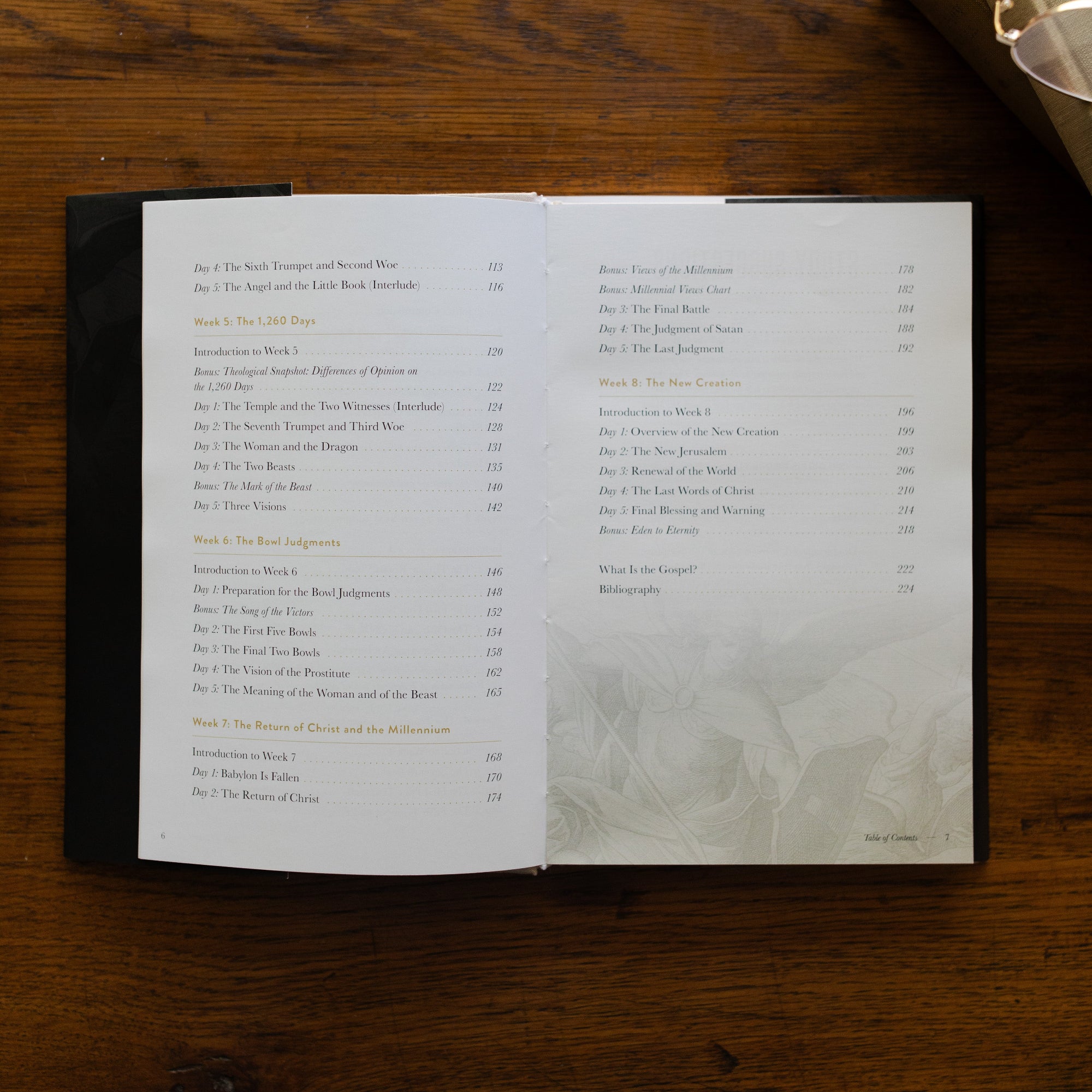Revelation Hardcover opened to the second page of the Table of Contents page on a wooden table