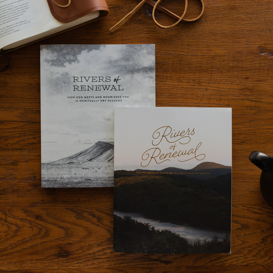 Rivers of Renewal His and Hers Study Cover on a brown wooden table next to a leather wrapped bible