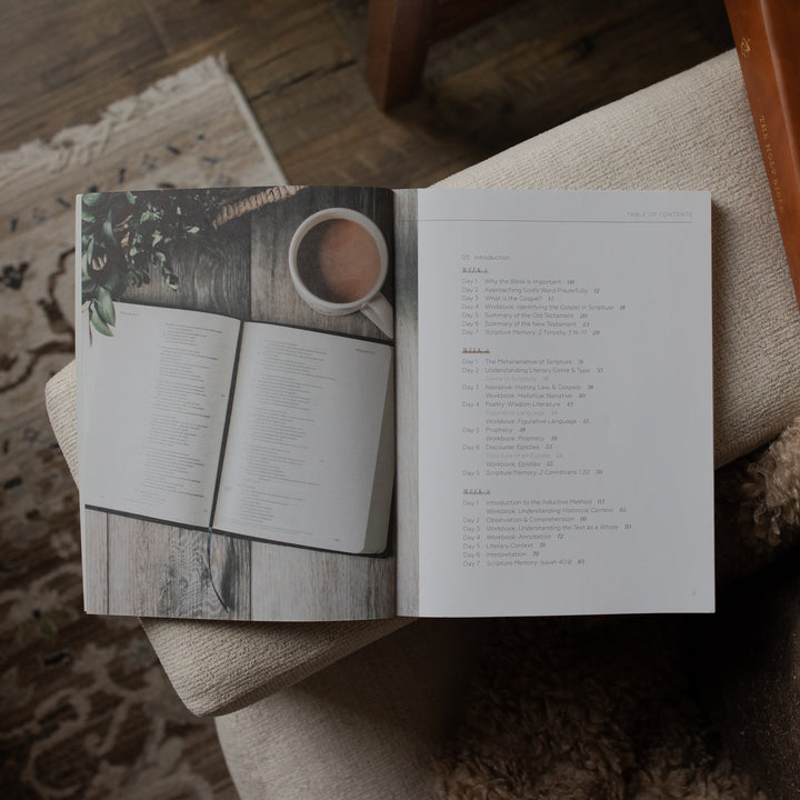 Open book with a coffee cup illustration on a wooden surface