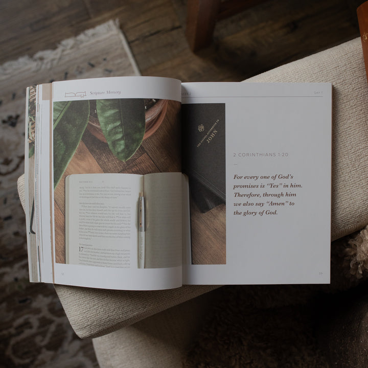 Open book with text and images on a wooden surface