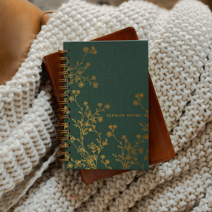 The Sermon Notes Journal with Green Floral on a bible and a knitted blanket